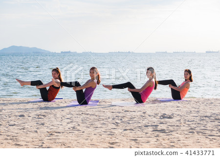Yoga class at sea beach in evening 41433771
