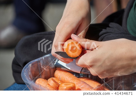 Cutting carrots with a knife 41434671