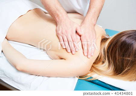 pretty woman or girl with sexy body and male hands of masseur therapist makes massage in beauty spa 41434801