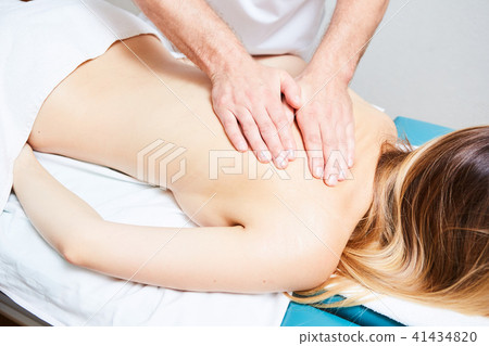 pretty woman or girl with sexy body and male hands of masseur therapist makes massage in beauty spa 41434820