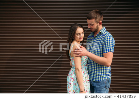 Young happy couple in love outdoors. Handsome man and beautiful woman on a walk in a spring blooming 41437859