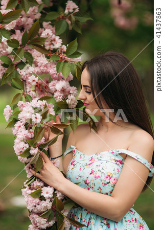 Beautiful girl near the blooming trees 41437863