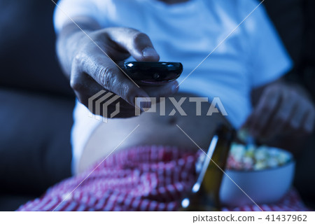 man drinking beer and eating popcorn man drinking beer and eating popcorn 41437962