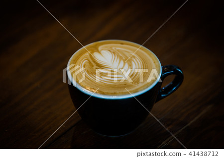 Coffee cup with latte art on wooden background . Coffee cup with latte art on wooden background . 41438712