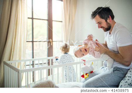 Father with toddler children in bedroom at home at bedtime. 41438975