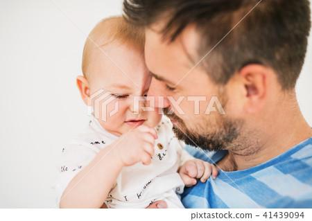 Portrait of a young father with a baby son at home. Close up. Portrait of a young father with a baby son at home. Close up. 41439094