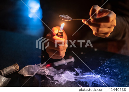 Male Junkie hand preparing heroin dose Male Junkie hand preparing heroin dose 41440588