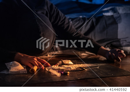 Junkie man trying to grab syringe of heroine Junkie man trying to grab syringe of heroine 41440592