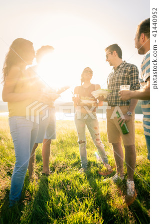 Group of friends standing in circle on barbecue party 41440952