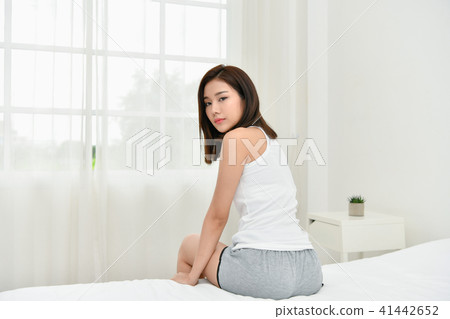 Lifestyle Concept. Beautiful asian woman is relaxing in a white Lifestyle Concept. Beautiful asian woman is relaxing in a white 41442652