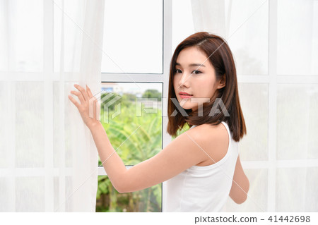 Lifestyle Concept. Beautiful asian woman is relaxing in a white Lifestyle Concept. Beautiful asian woman is relaxing in a white 41442698