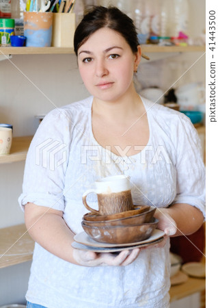 pottery business woman hold craft crockery plate pottery business woman hold craft crockery plate 41443500