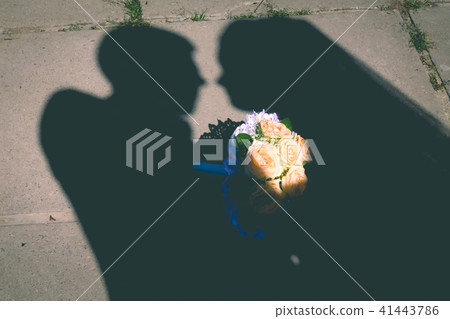 Young wedding couple enjoying romantic moments outside on a summer meadow 41443786