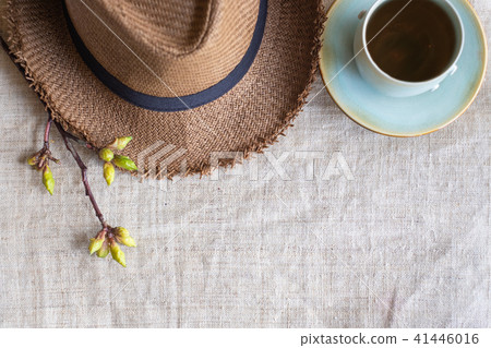 Summer brown panama straw hat with cup of tea 41446016
