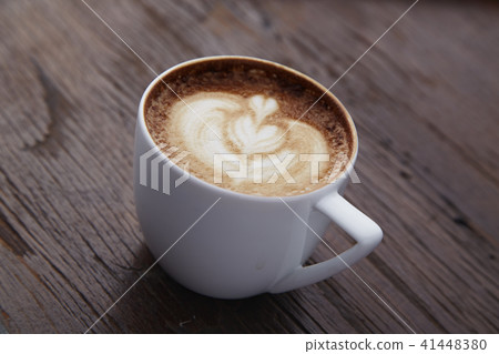 Cup of heart latte art on wood table 41448380