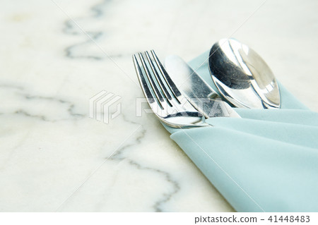 Cutlery Set a blue napkin on marble Cutlery Set a blue napkin on marble 41448483