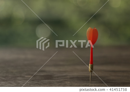 Red dart arrow with over blurred green background Red dart arrow with over blurred green background 41451738