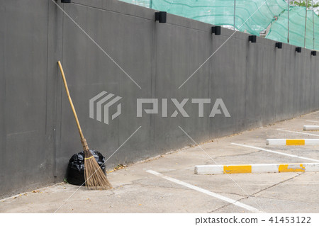 A black bag of garbage and old broom A black bag of garbage and old broom 41453122