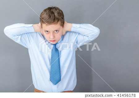 Boy under stress closes his ears 41456178