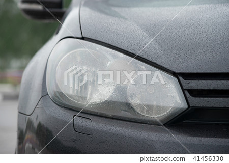 Black sports car front light coseup 41456330