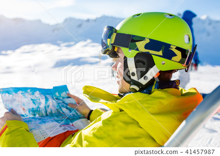 Image of sporty man in helmet sitting at chair 41457987