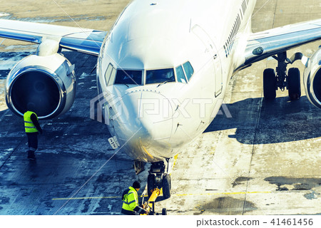 Close-up view to plane pushing back from gate Close-up view to plane pushing back from gate 41461456