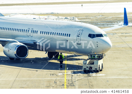 Unbranded plane pushing back from gate Unbranded plane pushing back from gate 41461458