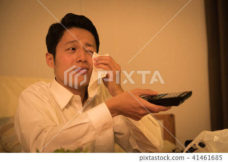 A young Japanese man who cries while watching TV 41461685
