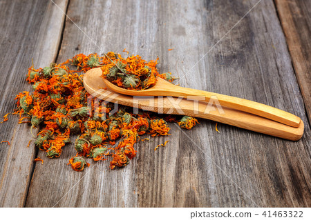 Dried calendula flowers on wooden Medicinal plants Dried calendula flowers on wooden Medicinal plants 41463322
