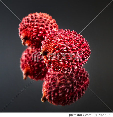 Tropical ripe litchi fruit isolated on a black glossy background Tropical ripe litchi fruit isolated on a black glossy background 41463422