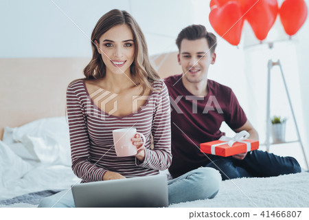 Delighted young woman looking at you Delighted young woman looking at you 41466807