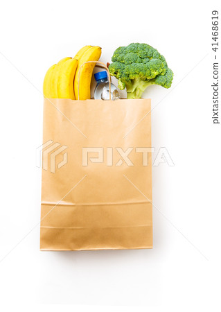 Photo of paper bag with broccoli and bananas, bottle of water 41468619