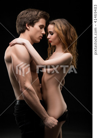 Beautiful couple shot embracing in the dark 41469483