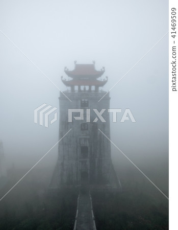 Temple tower on peak mountain in misty 41469509