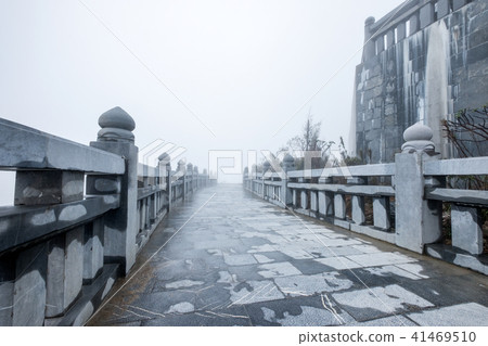 Stone rail and walkway with misty on hill 41469510