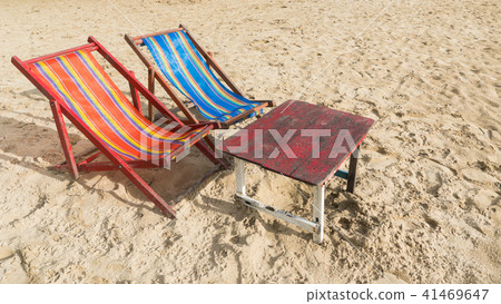 Red Blue Beach Chair with Wood Table on The Beach 41469647