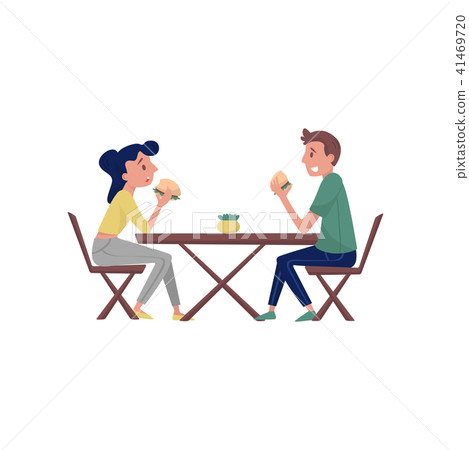 Young couple sitting behind wooden table and eating tasty burgers. Lunch time. Fast food theme. Flat 41469720