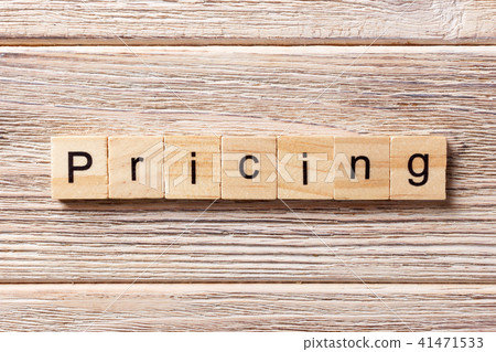 Pricing word written on wood block. 41471533