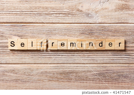 self reminder word written on wood block. 41471547