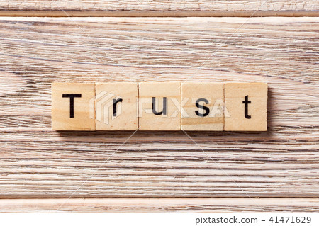TRUST word written on wood block. TRUST word written on wood block. 41471629