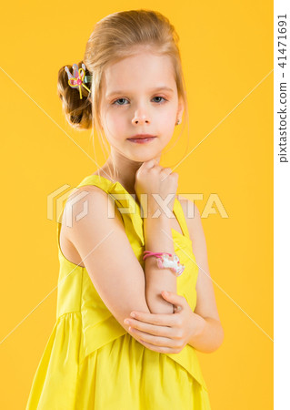 Girl posing on yellow background. Girl posing on yellow background. 41471691