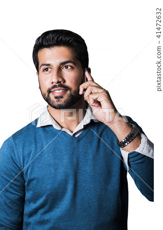 Smiling man standing in sweater with smart phone Smiling man standing in sweater with smart phone 41472632