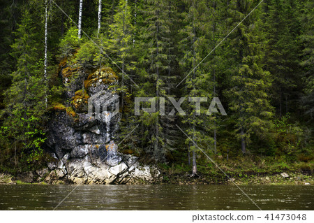 rock on the wooded bank of the river rock on the wooded bank of the river 41473048