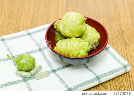 Green Noni or Morinda Citrifolia Fruits on Wooden Green Noni or Morinda Citrifolia Fruits on Wooden 41473078