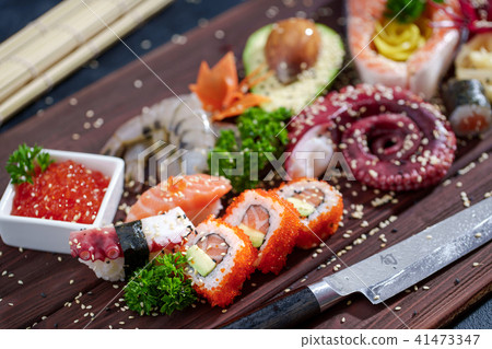 Sushi Set. Different sashimi, sushi and rolls with octopus Sushi Set. Different sashimi, sushi and rolls with octopus 41473347