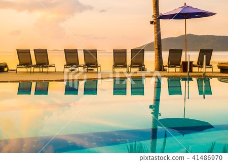 Beautiful outdoor view with umbrella and chair around swimming pool in luxury hotel and resort 41486970