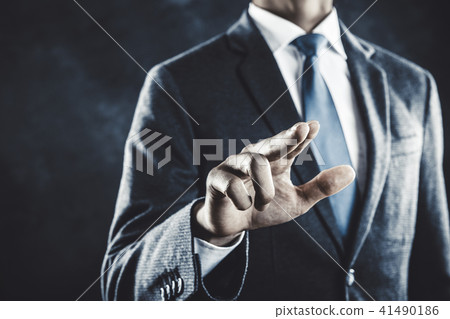 A businessman pointing a finger 41490186