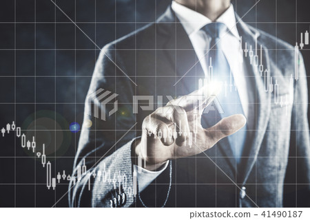 A businessman pointing to a chart 41490187