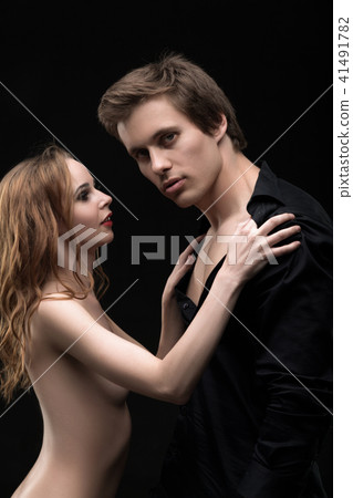 Sexy beautiful couple shot embracing against wall Sexy beautiful couple shot embracing against wall 41491782