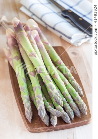 Bunch of fresh green asparagus on wooden board Bunch of fresh green asparagus on wooden board 41493924
